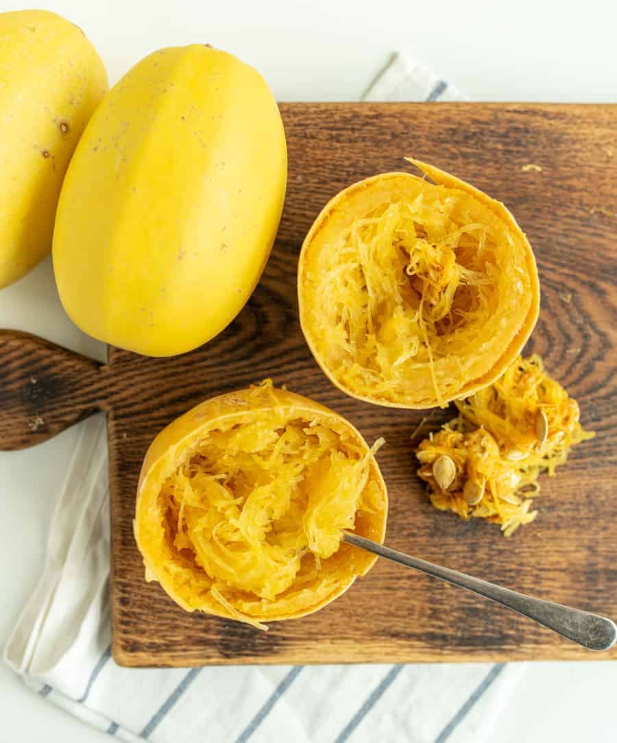 This simple recipe for how to cook a whole spaghetti squash in the slow cooker is the best set-it-and-forget-it hack -- you'll never go back to roasted spaghetti squash! #spaghettisquash #spaghetti #squash #slowcooker #crockpot