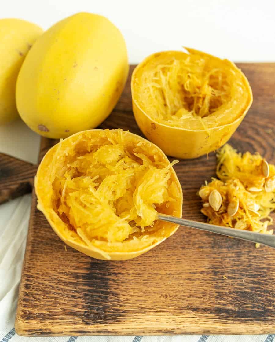 This simple recipe for how to cook a whole spaghetti squash in the slow cooker is the best set-it-and-forget-it hack -- you'll never go back to roasted spaghetti squash! #spaghettisquash #spaghetti #squash #slowcooker #crockpot