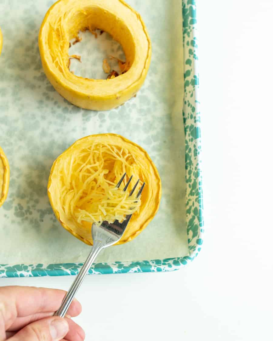 Get ready for the ultimate spaghetti and meatballs switcharoo... This spaghetti squash with meatballs and tomato sauce is just as delicious and flavorful with even more vitamins and nutrients! #spaghetti #spaghettisquash #spaghettiandmeatballs #healthypasta