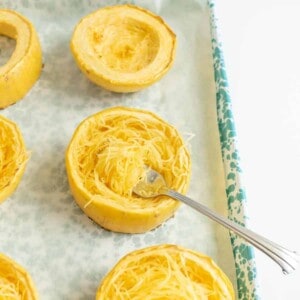 shredded spaghetti squash on a baking dish