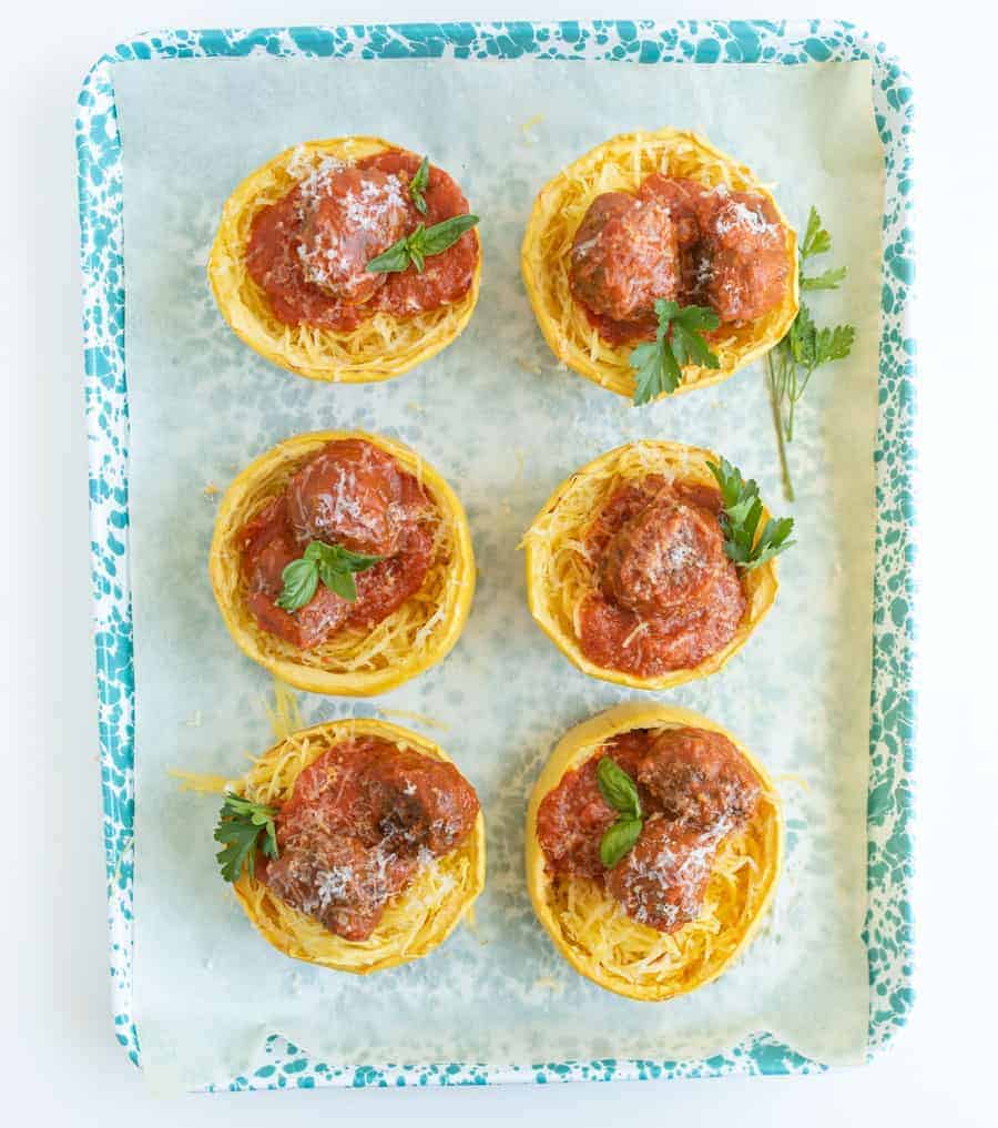 Get ready for the ultimate spaghetti and meatballs switcharoo... This spaghetti squash with meatballs and tomato sauce is just as delicious and flavorful with even more vitamins and nutrients! #spaghetti #spaghettisquash #spaghettiandmeatballs #healthypasta