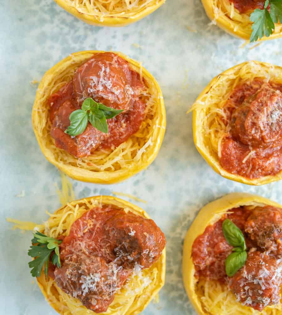 Get ready for the ultimate spaghetti and meatballs switcharoo... This spaghetti squash with meatballs and tomato sauce is just as delicious and flavorful with even more vitamins and nutrients! #spaghetti #spaghettisquash #spaghettiandmeatballs #healthypasta