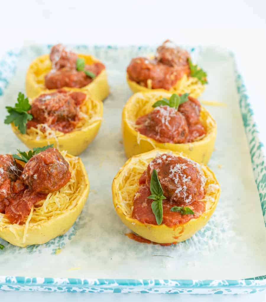 Get ready for the ultimate spaghetti and meatballs switcharoo... This spaghetti squash with meatballs and tomato sauce is just as delicious and flavorful with even more vitamins and nutrients! #spaghetti #spaghettisquash #spaghettiandmeatballs #healthypasta