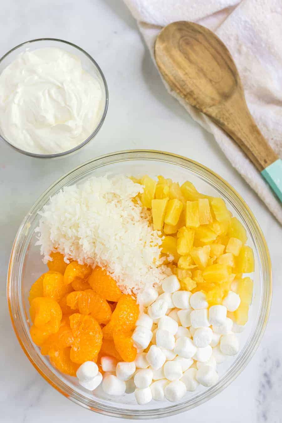 This tasty and creamy 6-cup ambrosia fruit salad is the simplest thing to make and is forever a hit for kiddos and adults alike at any gathering! #ambrosiafruitsalad #fruitsalad #fruit #fruitrecipes #salad #southerndishes #fruitsaladrecipe