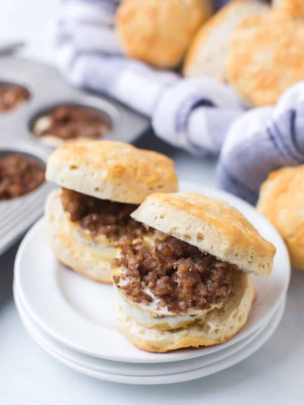 a plate of home made biscuits with ground sausage and egg in the middle