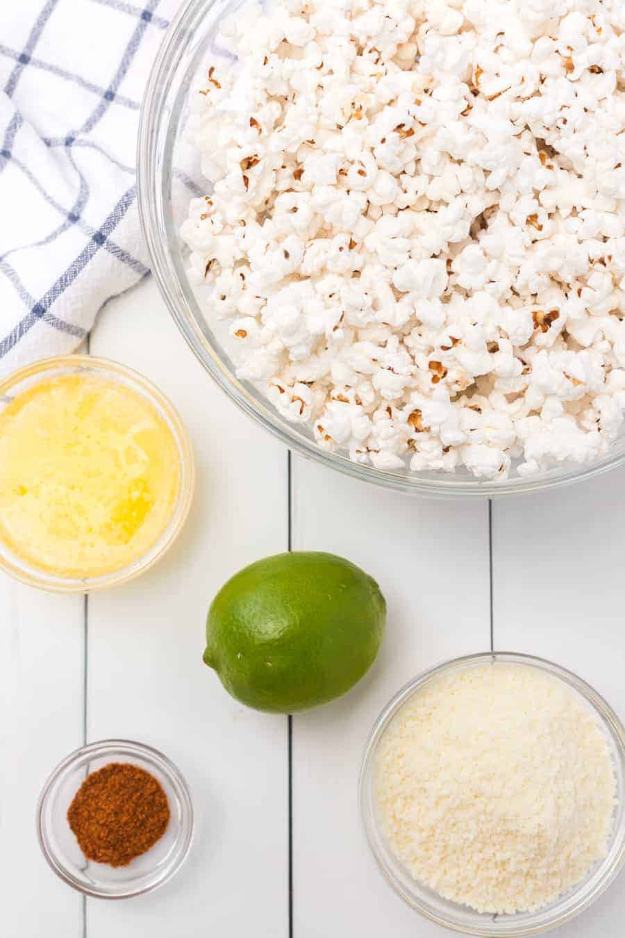 Quick and easy cheesy chili lime popcorn made with fresh popcorn, butter, cotija cheese, and chili powder make one tasty and simple snack. #popcorn #popcornrecipes #savorypopcorn #limepopcorn