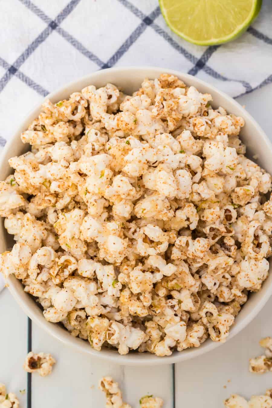 Quick and easy cheesy chili lime popcorn made with fresh popcorn, butter, cotija cheese, and chili powder make one tasty and simple snack. #popcorn #popcornrecipes #savorypopcorn #limepopcorn