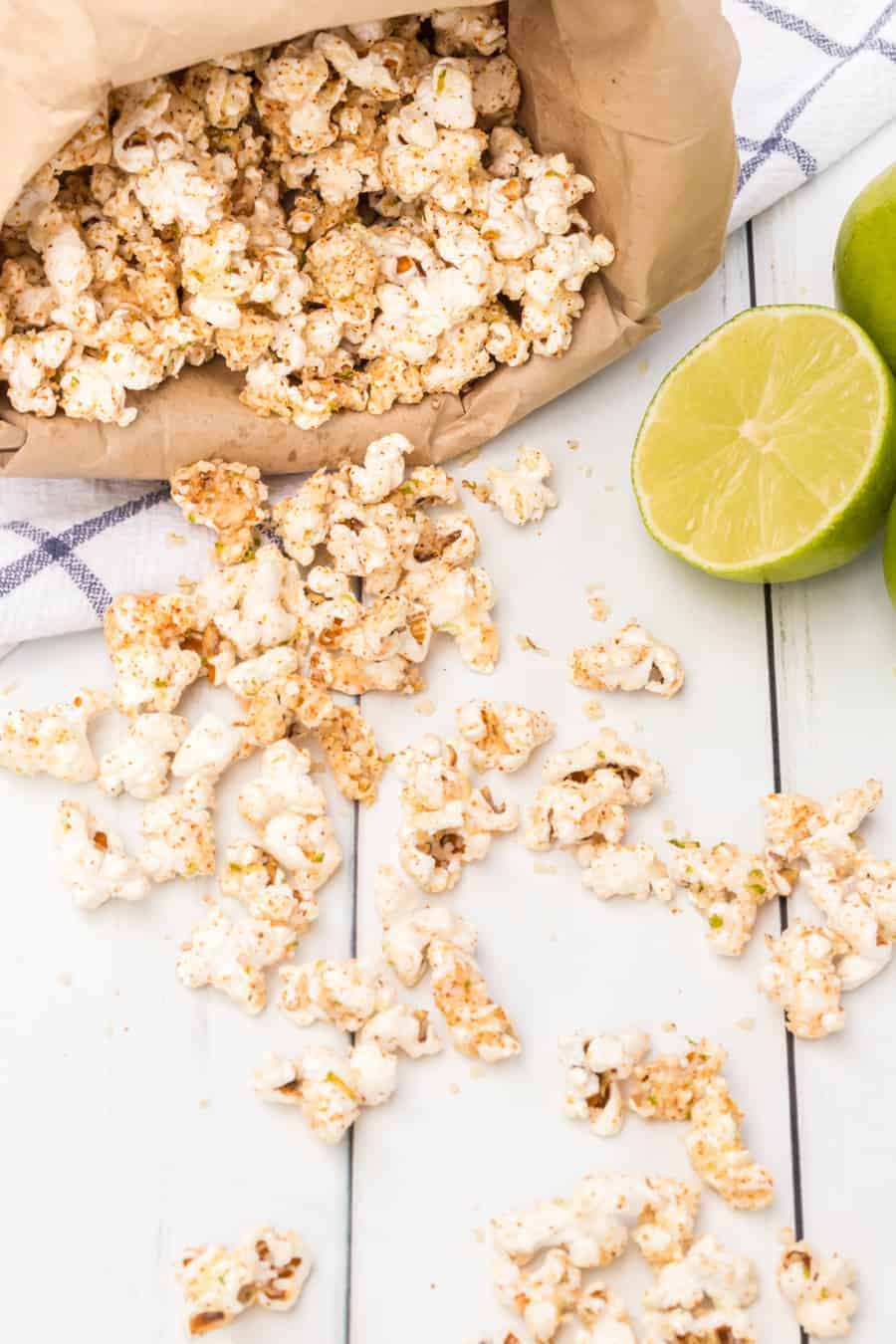 Quick and easy cheesy chili lime popcorn made with fresh popcorn, butter, cotija cheese, and chili powder make one tasty and simple snack. #popcorn #popcornrecipes #savorypopcorn #limepopcorn