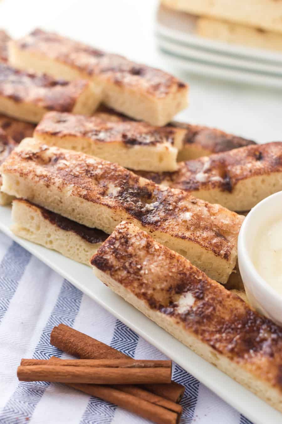 These warm, easy cinnamon sticks are SO good. They taste a lot like Pizza Hut’s cinnamon sticks, but not as greasy on the bottom. #cinnamonsticks #cinnamonbreadsticks #cinnamon #cinnamonbread #frosting #dessert