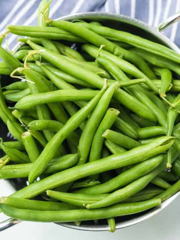 whole green beans overflowing in a pot