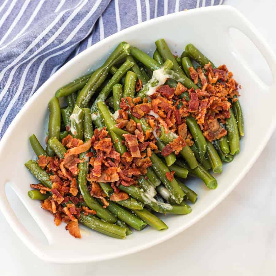 Green beans with butter and bacon is a hearty and flavor-filled side dish that takes green beans from plain to irresistible with just a handful of ingredients. #greenbeans #sides #sidedishes #veggiessides #bacon #southernsides 