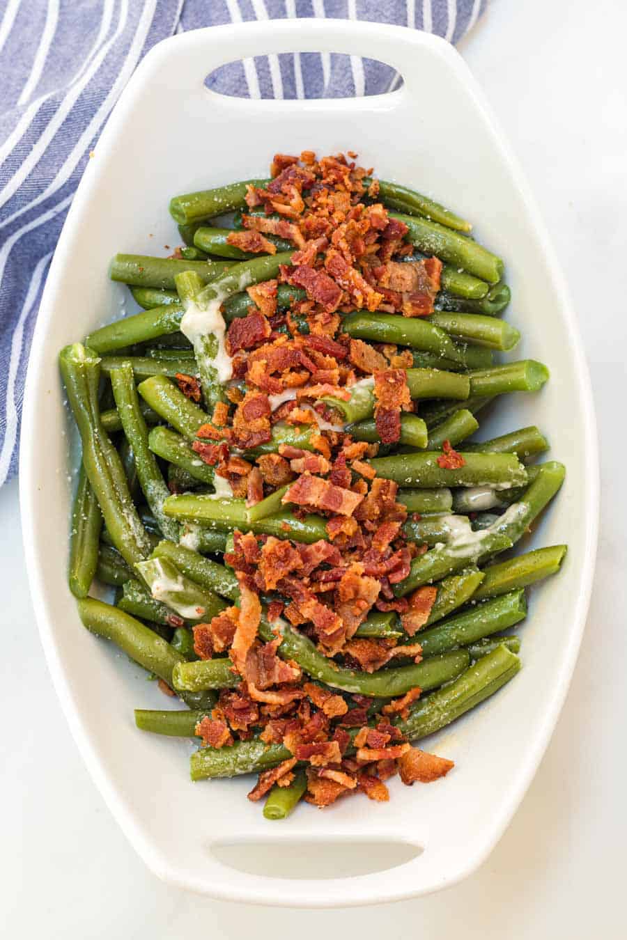 Green beans with butter and bacon is a hearty and flavor-filled side dish that takes green beans from plain to irresistible with just a handful of ingredients. #greenbeans #sides #sidedishes #veggiessides #bacon #southernsides 