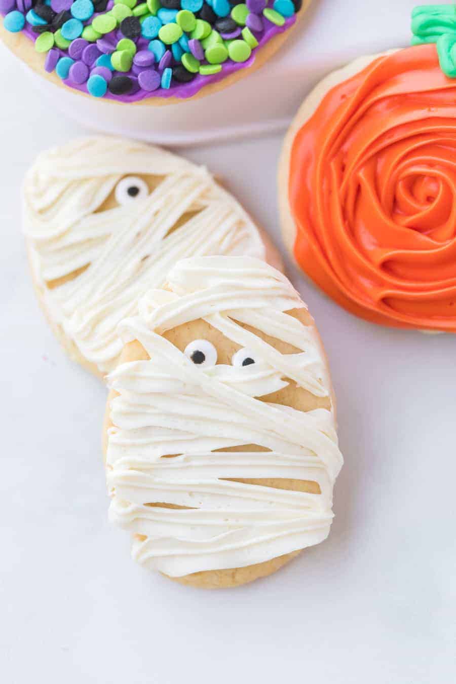 Halloween sugar cookies are adorable, soft, and sweet cookies that are sure to create wonderful memories baking with your family and festive treats for this spooky holiday! As a lover of sweets, I'm of the firm belief that sugar cookies aren't just for Christmas, and candy isn't just for Halloween! Celebrate this fun (and sometimes spooky) holiday by baking a big batch of these festive sugar cookies with your loved ones this Halloween season! #sugarcookies #cookies #halloweensugarcookies