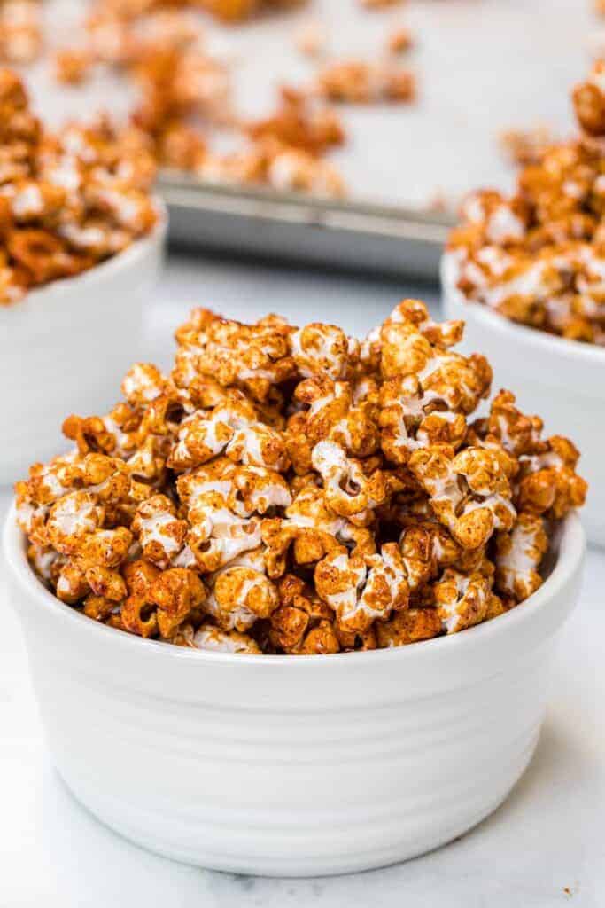 honey caramel corn, browned and looking like its full of flavor in three white bowls