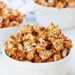 honey caramel corn, browned and looking like its full of flavor in three white bowls
