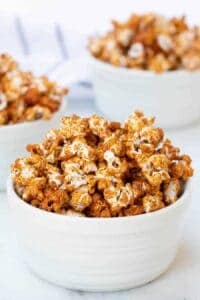 honey caramel corn, browned and looking like its full of flavor in three white bowls