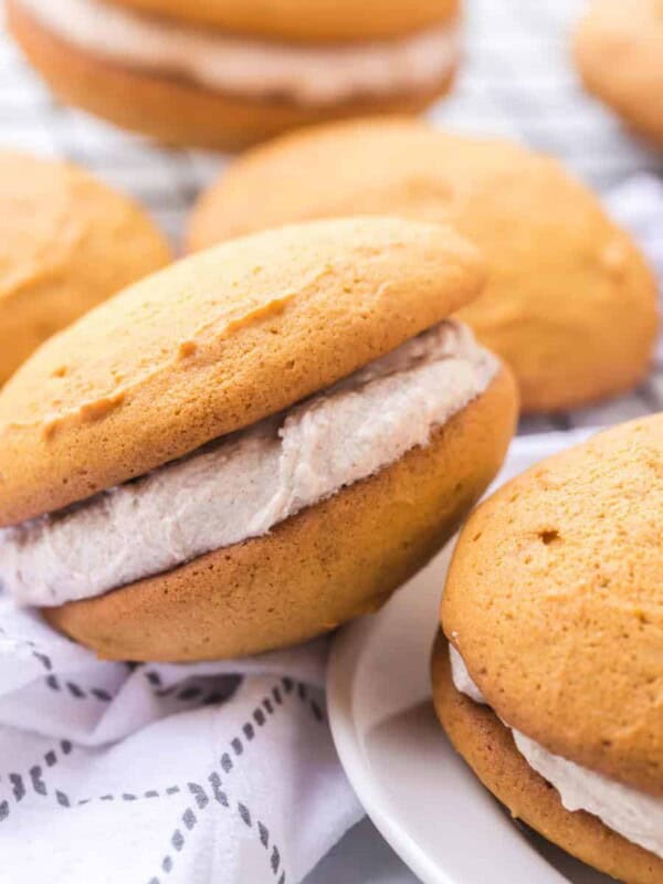 golden top and bottom with cinnamon speckled cream filling two whoopee pies stacked on top of each other