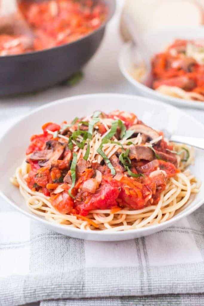 close up of steak and mushroom marinara over pasta