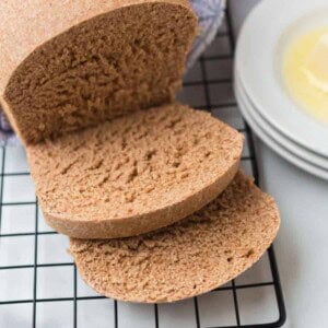 whole wheat bread on a cooling rack sliced
