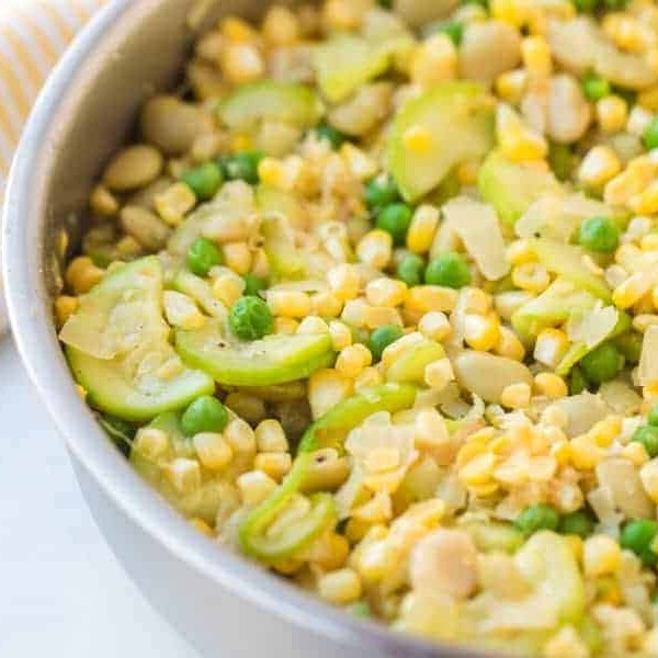 corn and yellow squash side dish in a white bowl