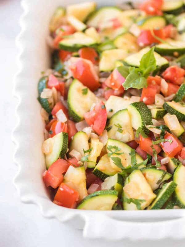 zucchini and tomato side dish in a baking pan.