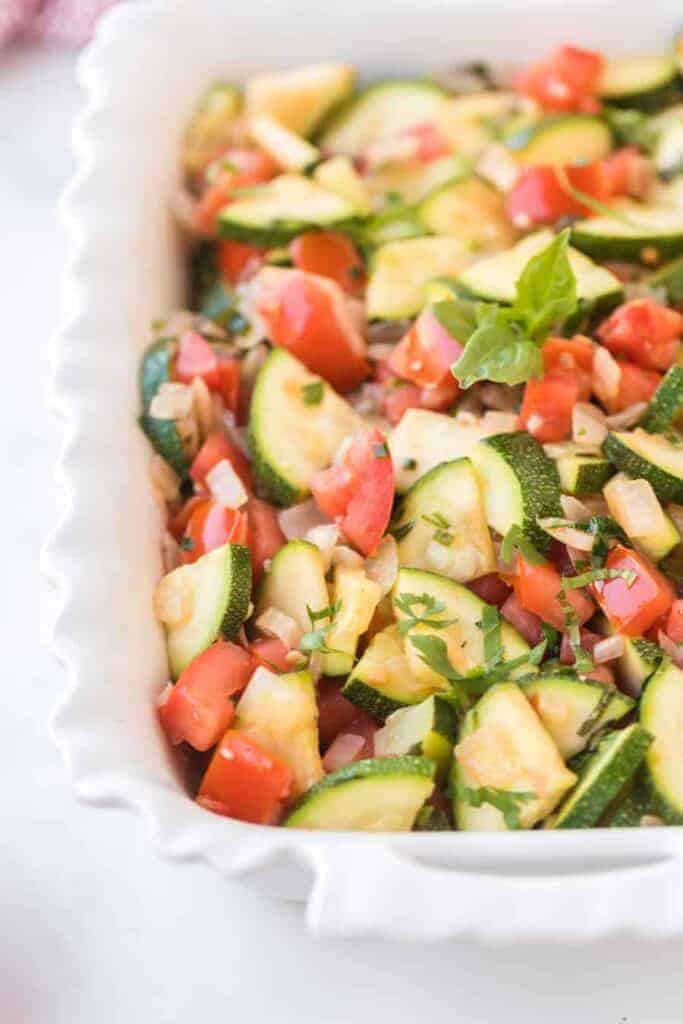 zucchini and tomato side dish in a baking pan