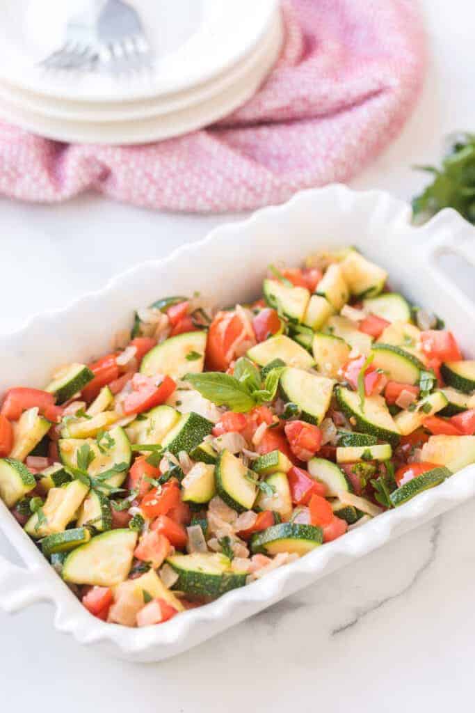 zucchini and tomato side dish in a baking pan