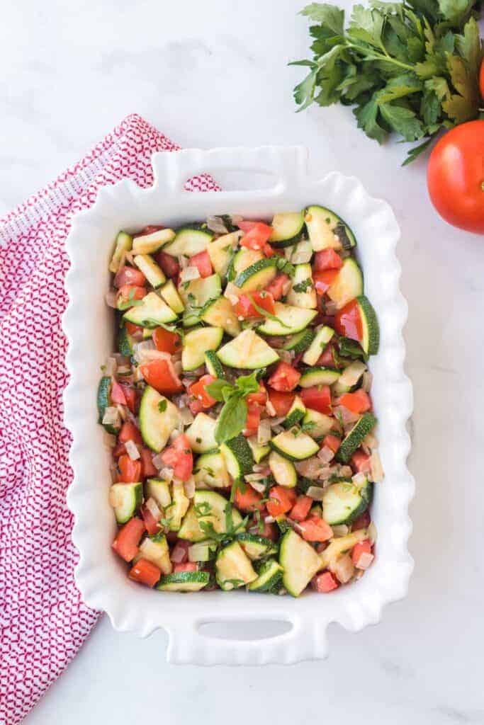 top view of zucchini and tomato side dish in a baking pan
