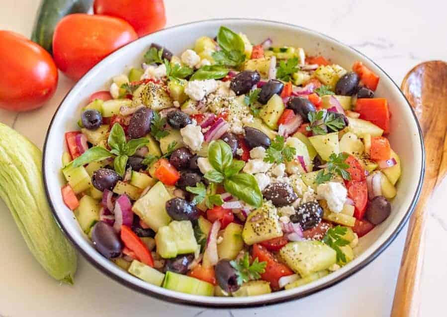 A refreshing and easy taste of summer, this Mediterranean cucumber salad is packed with fresh ingredients and flavors that you can totally make your own! #olives #healthy #salad #cucumber