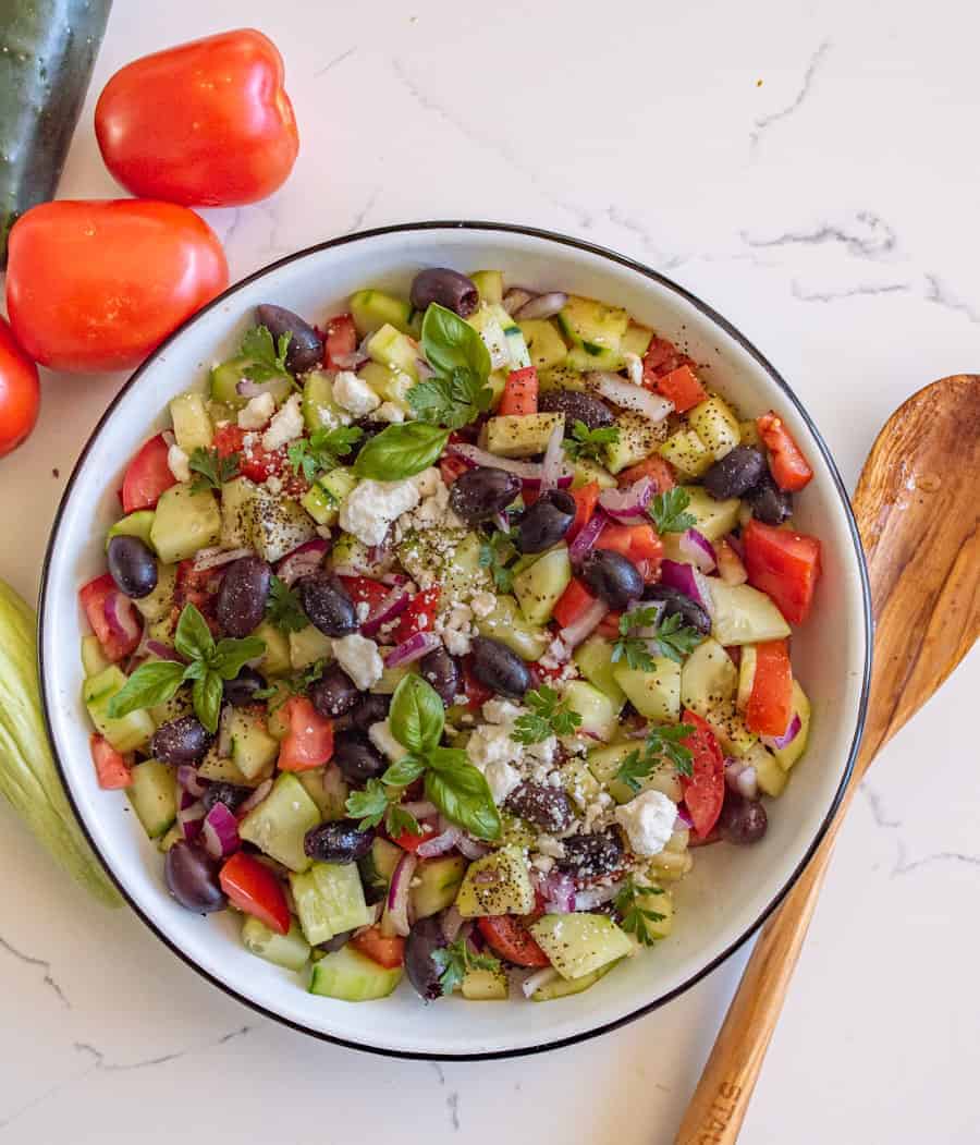 A refreshing and easy taste of summer, this Mediterranean cucumber salad is packed with fresh ingredients and flavors that you can totally make your own! #olives #healthy #salad #cucumber