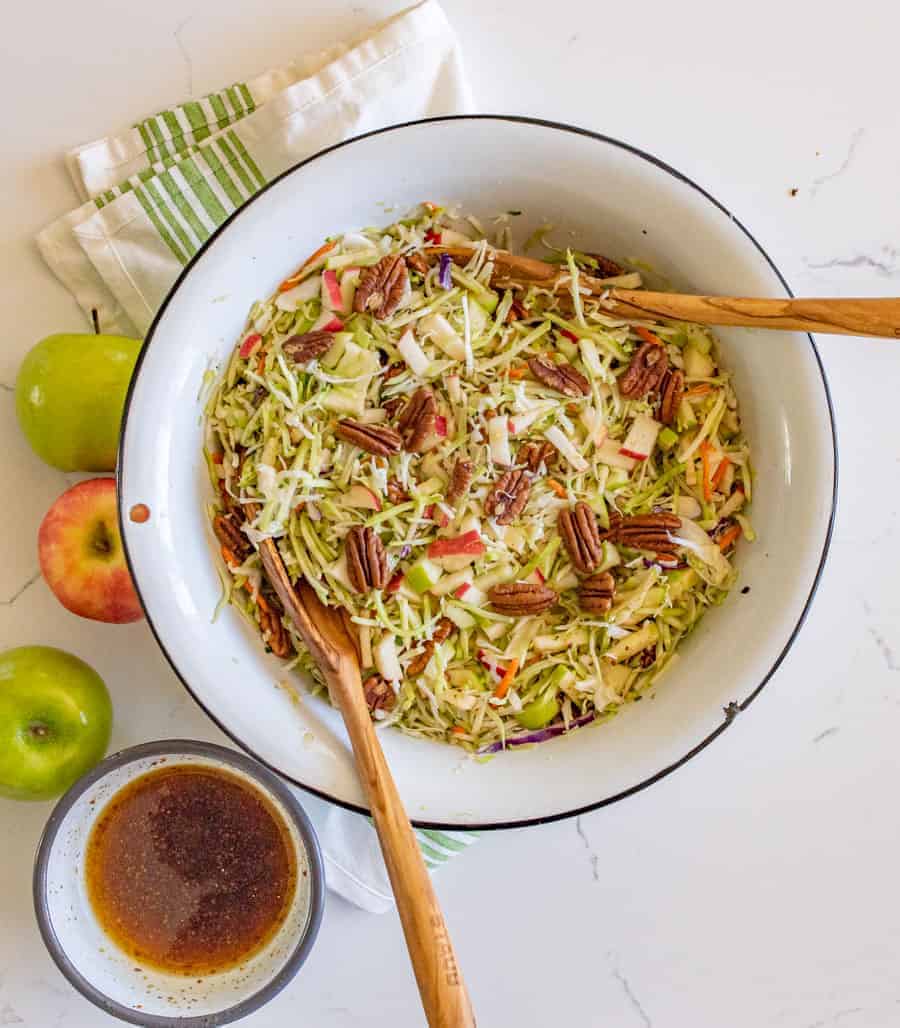 Apple cabbage salad with pecans is a crunchy and bright salad similar to cole slaw with just a hint of sweetness from the fruit. #cabbagesalad #coleslaw #applecabbagesalad #applesalad #cabbage #salad