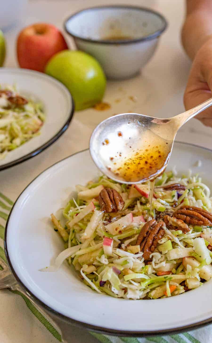 Apple cabbage salad with pecans is a crunchy and bright salad similar to cole slaw with just a hint of sweetness from the fruit. #cabbagesalad #coleslaw #applecabbagesalad #applesalad #cabbage #salad