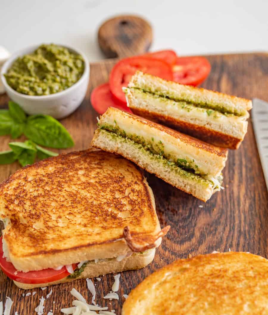Pesto grilled cheese sandwiches are a super fun and delicious way to simply dress up the classic handheld lunch staple with tried-and-true flavors that taste heavenly together. #grilledcheese #pestogrilledcheese #pesto #sandwich #homemadepesto