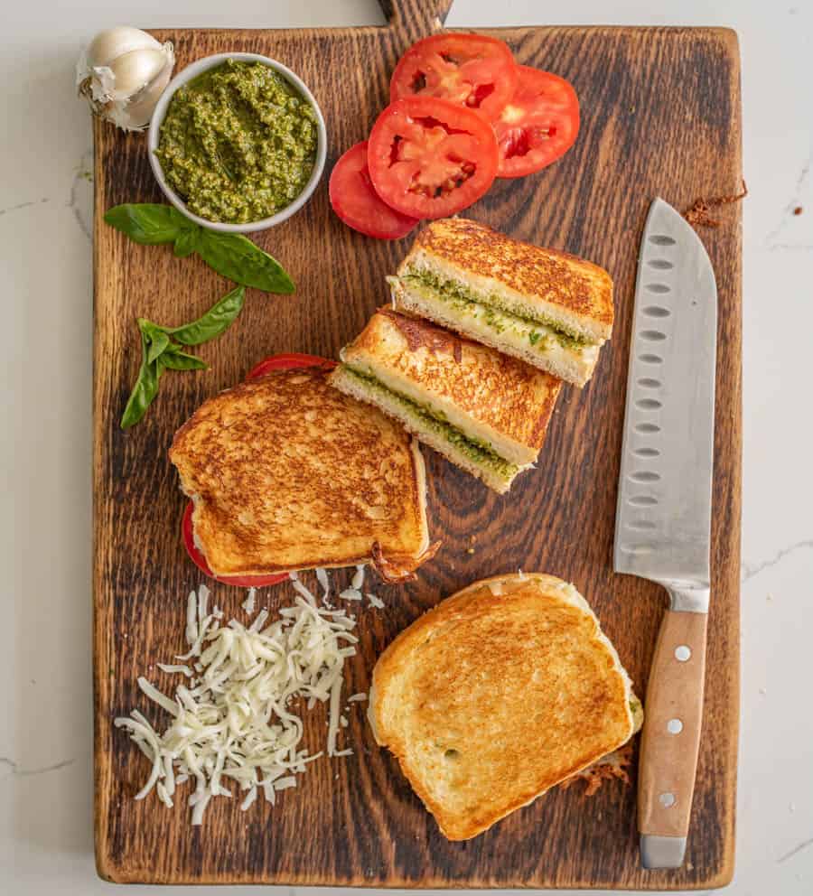 Pesto grilled cheese sandwiches are a super fun and delicious way to simply dress up the classic handheld lunch staple with tried-and-true flavors that taste heavenly together. #grilledcheese #pestogrilledcheese #pesto #sandwich #homemadepesto