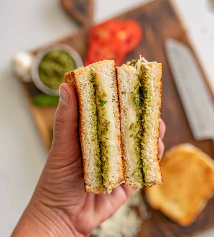 Pesto grilled cheese sandwiches are a super fun and delicious way to simply dress up the classic handheld lunch staple with tried-and-true flavors that taste heavenly together. #grilledcheese #pestogrilledcheese #pesto #sandwich #homemadepesto
