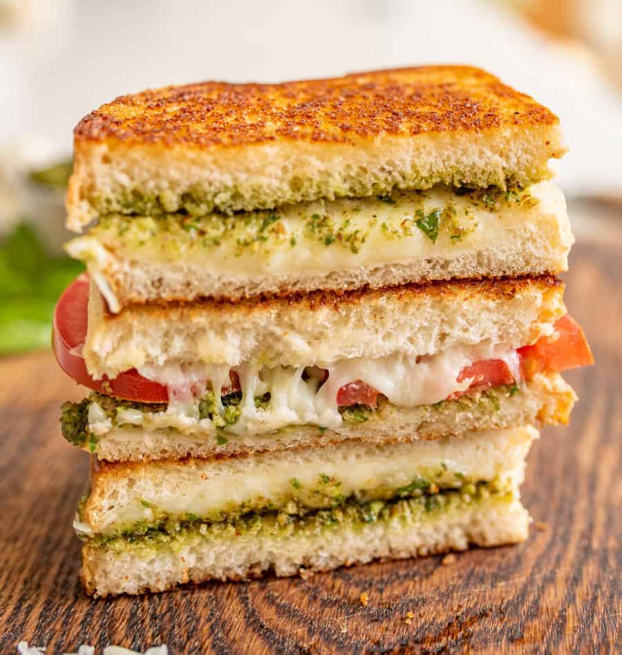 Pesto grilled cheese sandwiches are a super fun and delicious way to simply dress up the classic handheld lunch staple with tried-and-true flavors that taste heavenly together. #grilledcheese #pestogrilledcheese #pesto #sandwich #homemadepesto