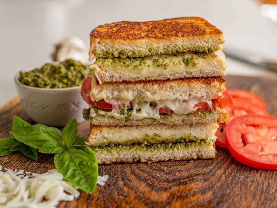 Pesto grilled cheese sandwiches are a super fun and delicious way to simply dress up the classic handheld lunch staple with tried-and-true flavors that taste heavenly together. #grilledcheese #pestogrilledcheese #pesto #sandwich #homemadepesto