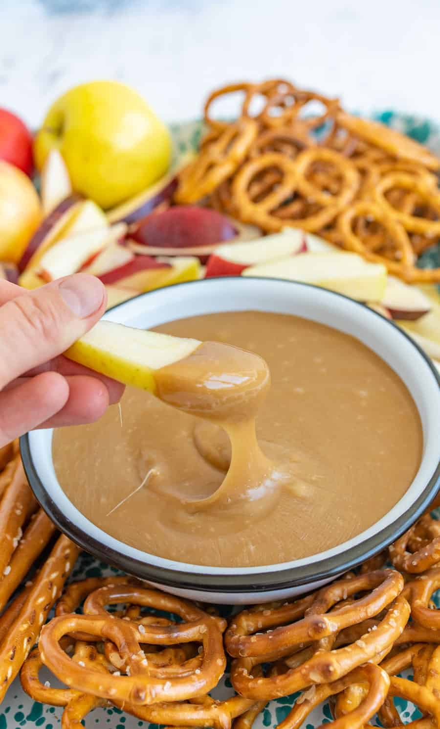 This is the best caramel dip ever. Made on the stove with butter, sugar, and sweetened condensed milk, it's the perfect consistency for dipping pretzels and apples. #homemadecaramel #carameldip #easycaramelrecipe #bestcaramel #thebestcaramel #bestcaramelrecipe #caramelapples #dippingcaramel
