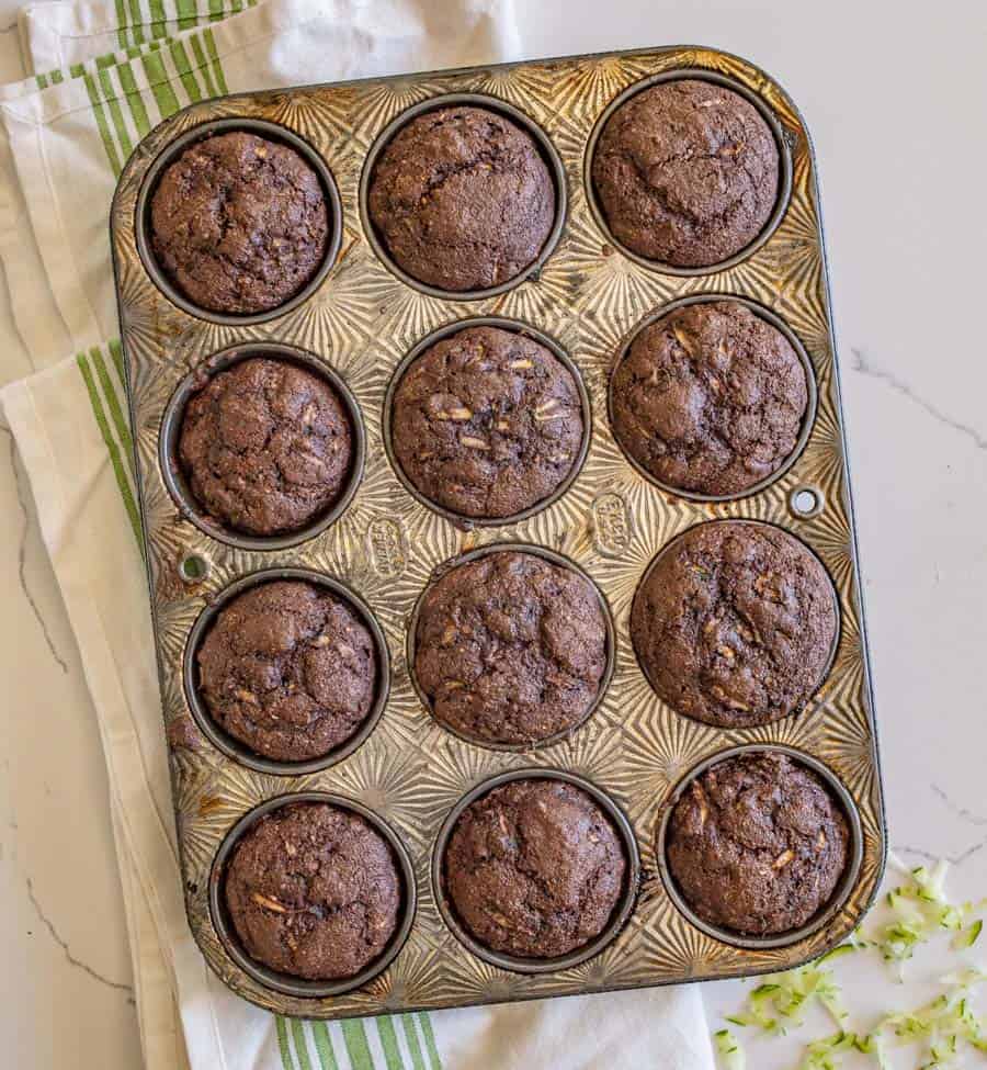 top view chocolate zucchini muffins in a small muffin tin