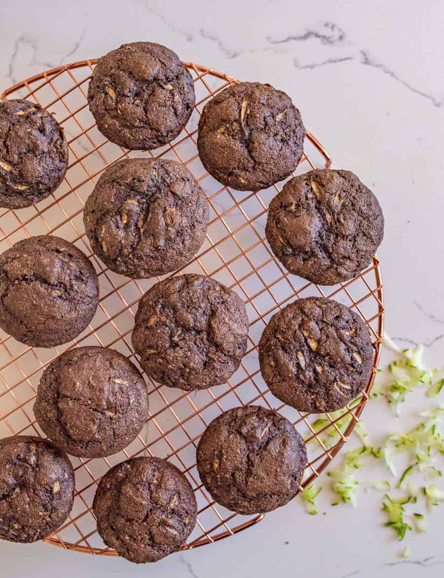 Healthy chocolate zucchini muffins are so yummy and make for a perfect snack or lunchtime dessert, made with whole wheat flour, maple syrup, applesauce, grated zucchini, and mini chocolate chips! #chocolatemuffins #zucchinimuffins #muffins #healthymuffins #muffinrecipe #chocolatezucchinimuffins