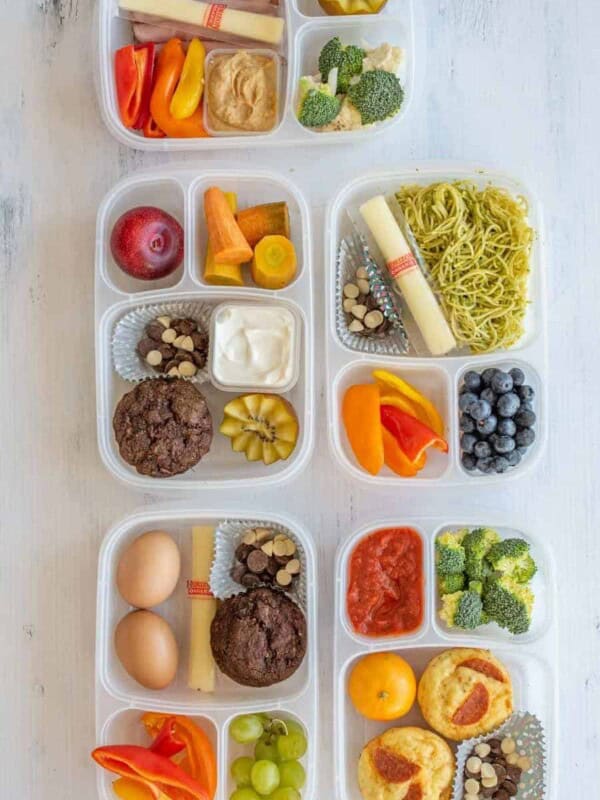 many different tupperware with compartments for different lunch ingredients and chocolate milk on the side