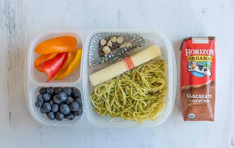 tupperware with compartments for different lunch ingredients and chocolate milk on the side.