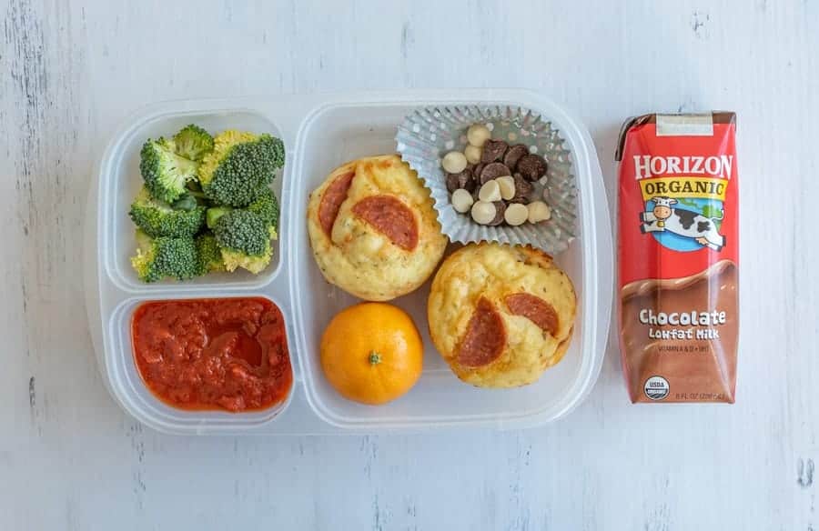 tupperware with compartments for different lunch ingredients and chocolate milk on the side.