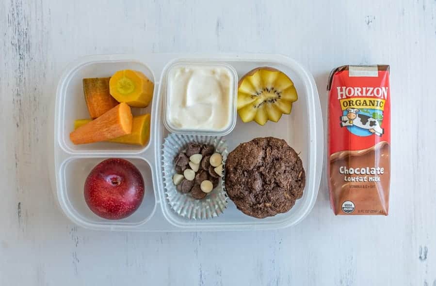 tupperware with compartments for different lunch ingredients and chocolate milk on the side.