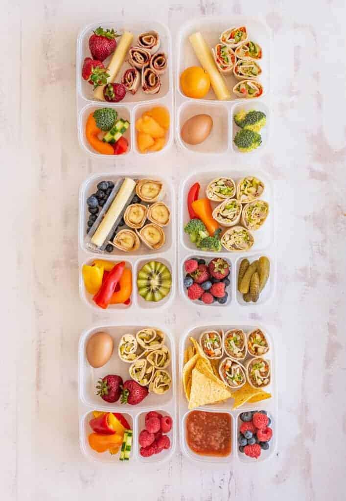 several tupperware with lunch items separated in compartments