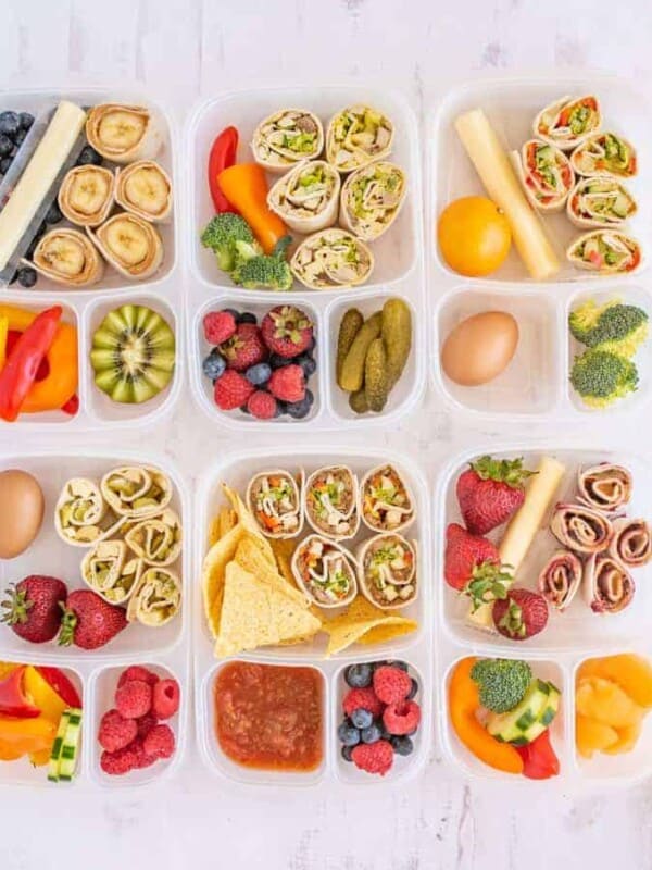 lots of different tupperware with lunch items separated in compartments