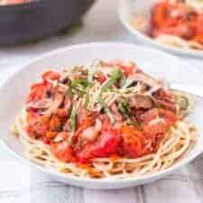steak and mushroom marinara sauce on top of pasta.