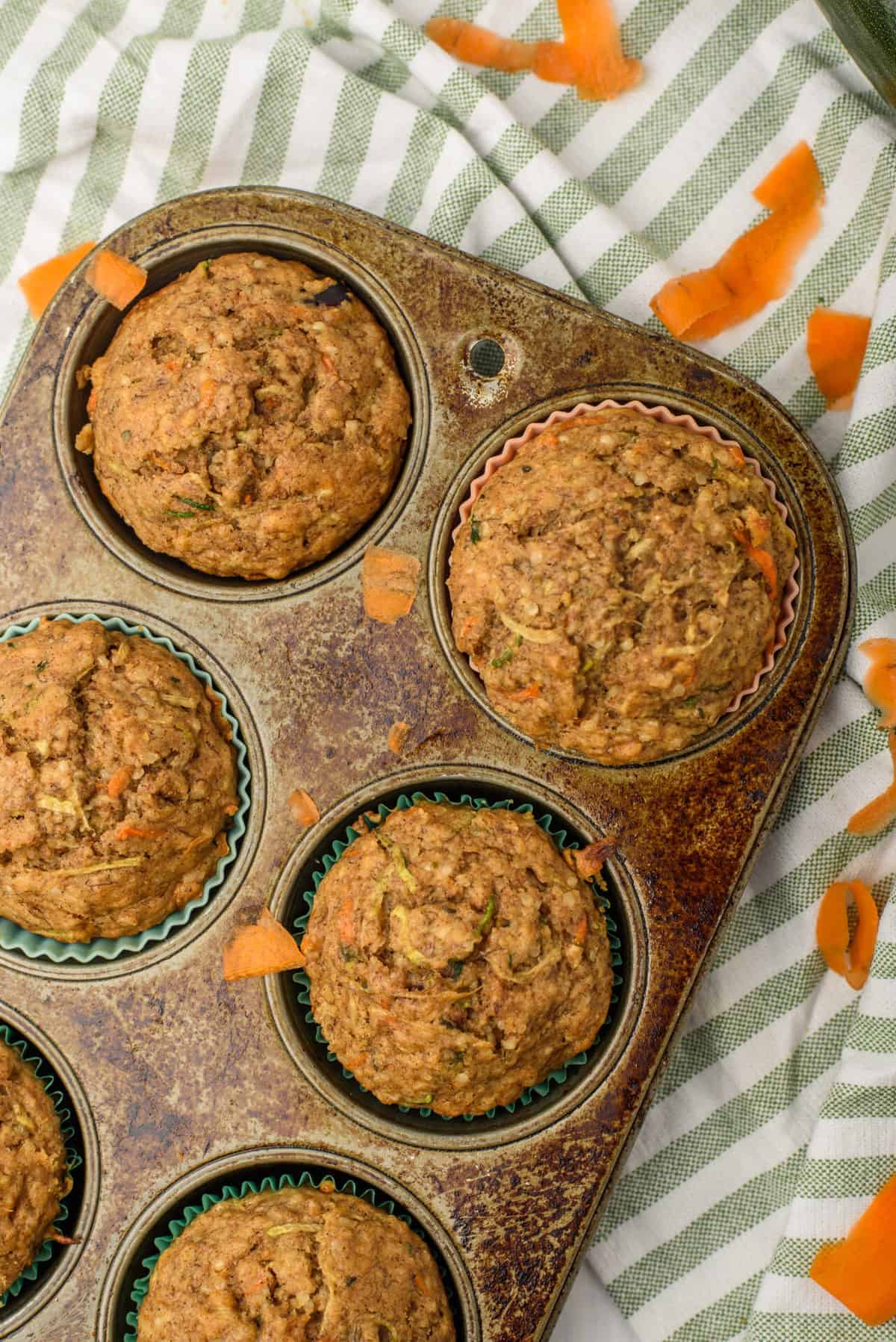 Healthy carrot cake zucchini muffins come together in just a half hour and have all your favorite carrot cake flavors with an added kick of nutrients from wholesome ingredients! #carrotcakemuffins #healthycarrotcake #carrotcakezucchinimuffins #carrotcakemuffinrecipe #carrotcake #healthymuffins