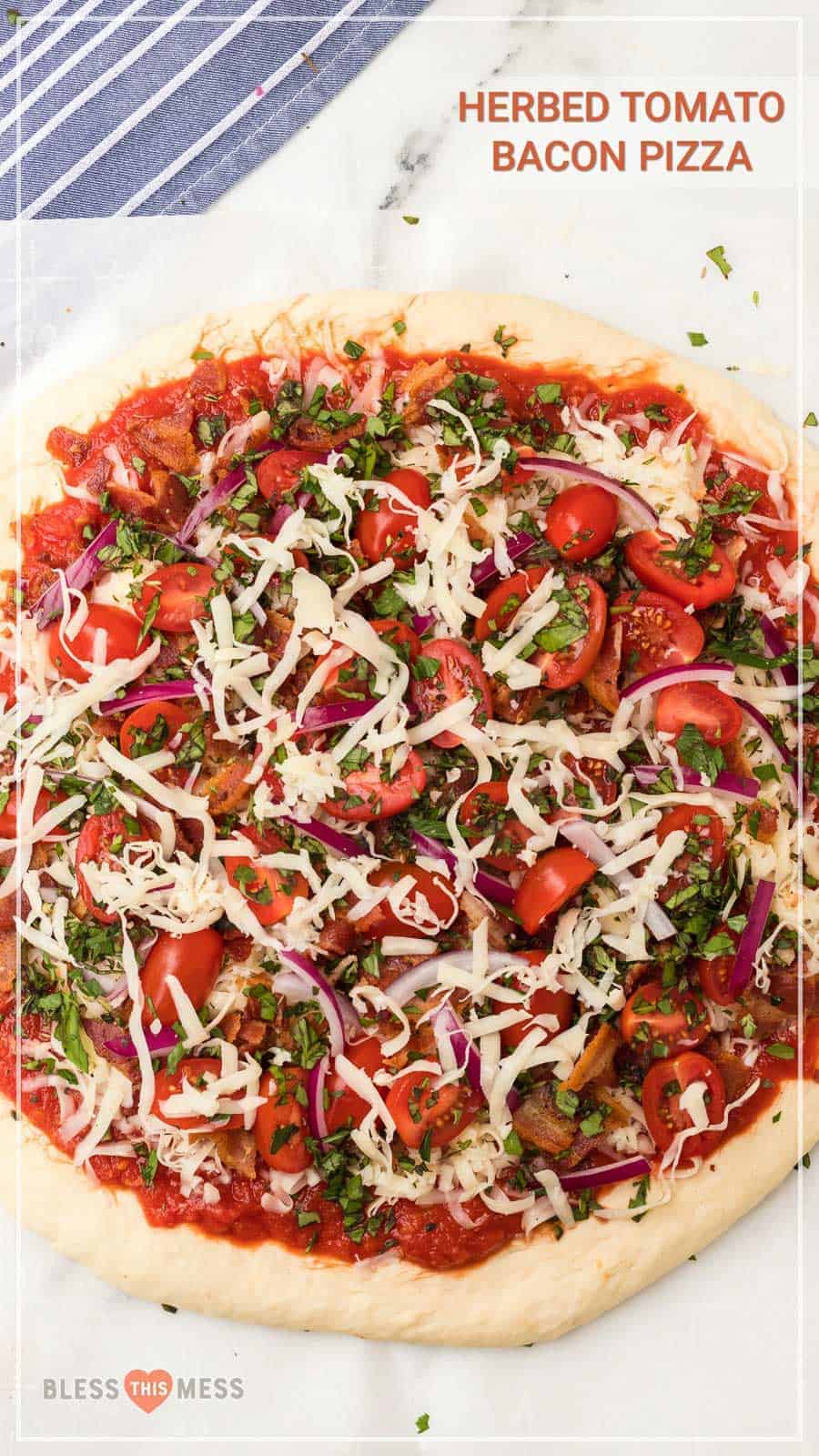 Homemade pizza dough topped with bacon, cheese, tomatoes, and herbs is the perfect pizza to make tonight. Your whole family will love it! #pizza #homemadepizza #tomatobaconpizza