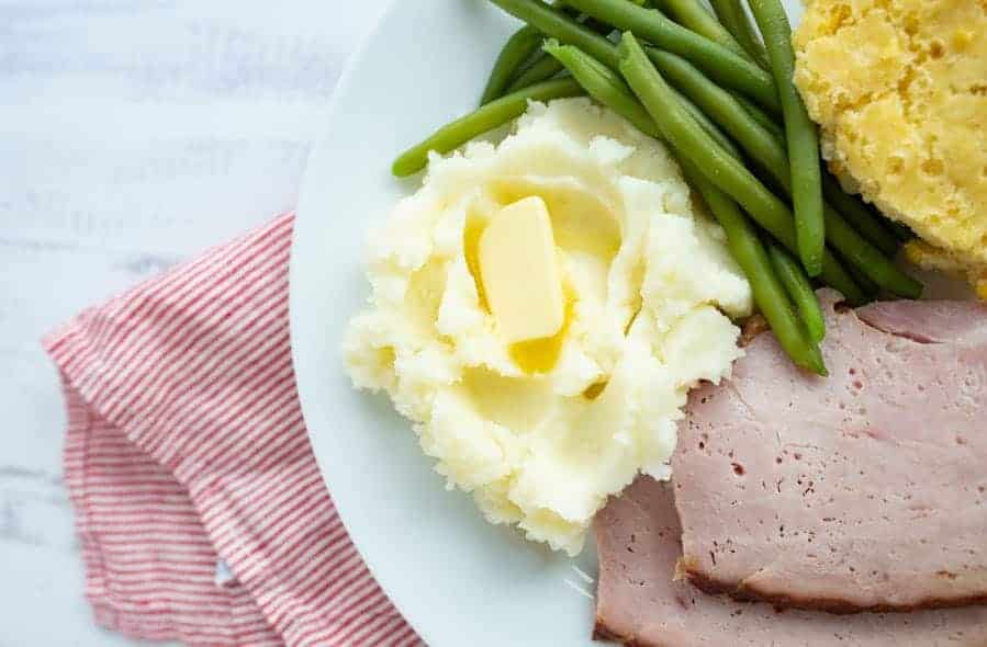 close up of thanksgiving dinner on a white plate
